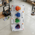 3D Printed Articulated Spider Toy Ornament alongside vibrant 3D printed designs in a creative workspace.