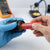 Person inserting a Rechargeable Cylindrical Battery Cell into a device, demonstrating its compatibility in electronics.