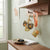 Capybara Acrylic Bag Pendant Keychain hanging on shelf near keys and decor, showcasing playful animal-inspired design.