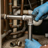 Plumber installing a 304 Stainless Steel 90 Degree Elbow Pipe Fitting in a pipe system.
