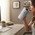 Woman sipping from a 350ml Stainless Steel Travel Mug at a desk with a computer.