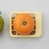 Playful Produce Cutting Set featuring an orange piece on a yellow cutting board with a green basket.