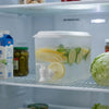 3.5L Beverage Dispenser with Tap and Lid in refrigerator filled with lemon and lime slices.