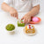 Child playing with Pretend Bakery Treats Play Set, featuring colorful desserts like macarons and cake pieces.