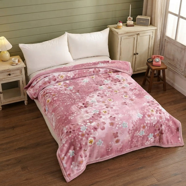 Soft Printed Blanket laid over a bed, featuring a floral design in pink, enhancing cozy and stylish home décor.