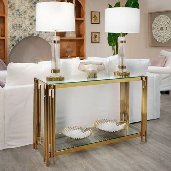 Glass Gold Decorative Console Table with elegant gold rods, clear glass shelf, and tabletop lamps in a modern living room.