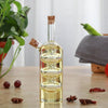 2 in 1 Olive Oil Vinegar Bottle Dispenser with cork stopper and decorative design in a kitchen setting.