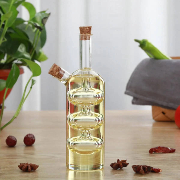 2 in 1 Olive Oil Vinegar Bottle Dispenser with cork stopper and decorative design in a kitchen setting.