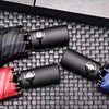 3-Fold Minimalist Automatic Umbrella in red, blue, and black on a textured surface with buttons.