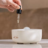 Person adding essential oil to the 400ml Ultrasonic Essential Oil Diffuser with Remote Control.