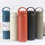 Stainless Steel Wide Mouth Sport Thermos in various colors lined up on a table.