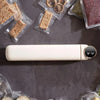 Portable Mini Food Vacuum Packing Organising Sealer on a countertop surrounded by vacuum-sealed snacks and fruits.