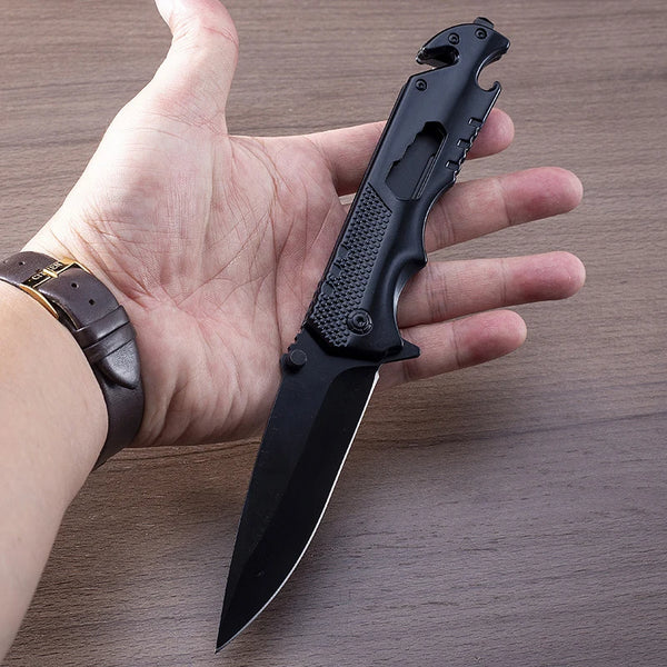 Iron Grip Full Metal Survival Folding Knife held in hand, showcasing its rugged design and sharp cutting edge.