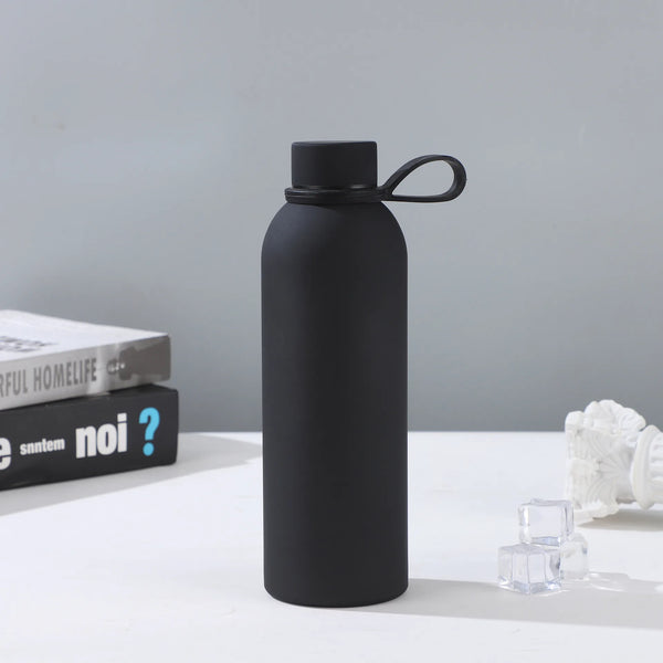 500ml Matte Rubberized Insulated Sports Bottle on a table with ice cubes and books in the background.