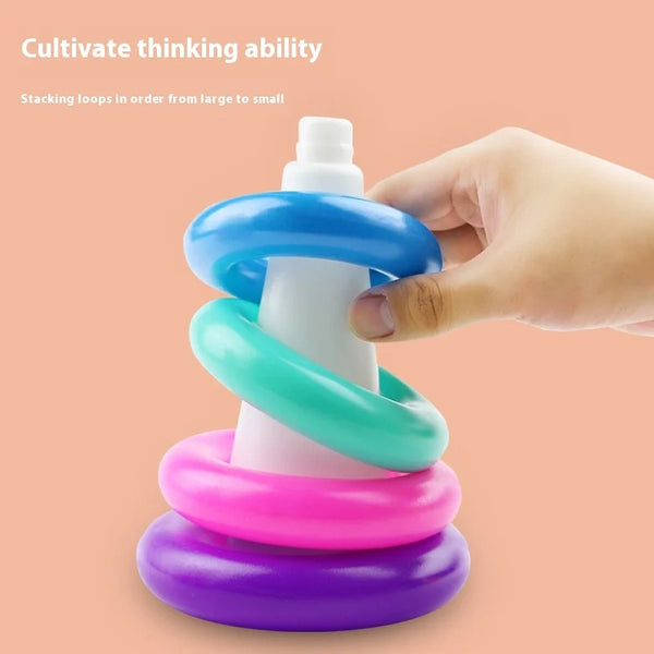 Colorful Rainbow Tower Duck Stacking Ring Toy with hand, promoting fine motor skills and hand-eye coordination.