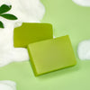 Aichun Beauty Natural Beard Cleaning Soap bars on a green background with bubbles.