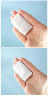 Hand holding 3 Layers Square Cotton Pads on a light blue background, showcasing the product's texture and size.
