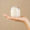 Electric Fabric Lint Remover in a hand, designed for removing lint and fuzz from fabrics.