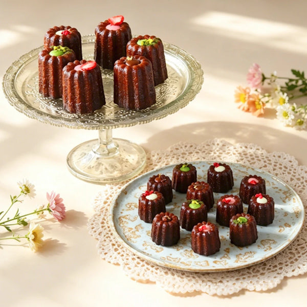 Carbon Steel 6-Cup Cannelé Baking Tray with beautifully decorated cannelés on elegant plates.
