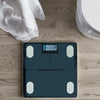 Bluetooth Digital Smart Bathroom Scale on wooden floor next to a towel and toilet.