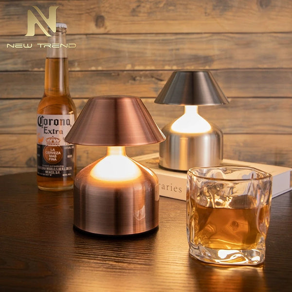 Retro Acrylic LED Desk Lamp Glow on a table with a drink and a beer bottle, creating a warm atmosphere.
