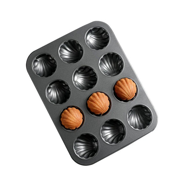 Carbon Steel Shell Shape Baking Mold with baked madeleines in a durable tray for perfect fluted treats.