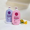 AHA Soothing 24H Moisture Body Lotion and AHA Brightening 24H Moisture Body Lotion displayed together with flowers.