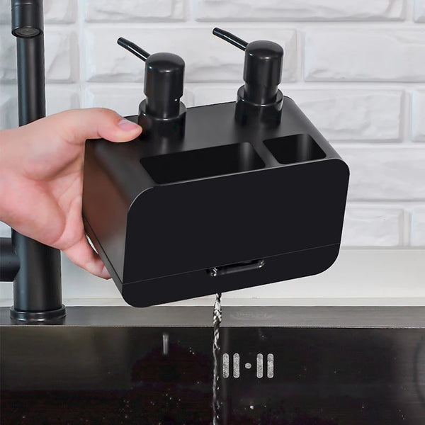 Hand holding a Waterproof Durable Portable Dispenser above a kitchen sink, showcasing its sleek black design and soap dispensing feature.