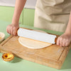 Non-Stick Wooden Handle Silicone Rolling Pin being used to roll out dough on a wooden board.