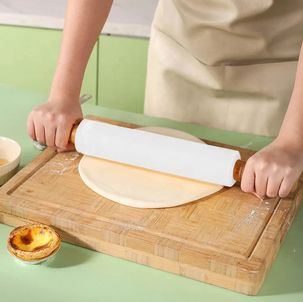 Non-Stick Wooden Handle Silicone Rolling Pin being used to roll out dough on a wooden board.