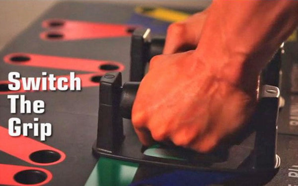Close-up of a hand switching grip on a Complete Push Up Training System for enhanced workout effectiveness.