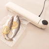 Portable Mini Food Vacuum Packing Organising Sealer vacuum sealing two fish with lemon slices