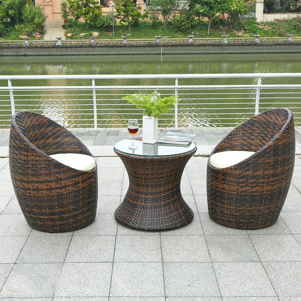 Garden Lounge Wicker Furniture Set featuring stylish chairs and modern round table by the water.