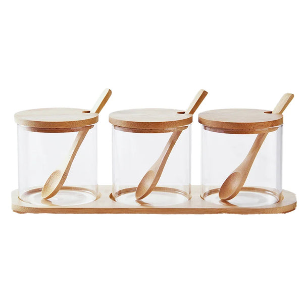 Glass Seasoning Jar Spice Container set with wooden lids and spoons on a bamboo tray.