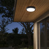 Waterproof Outdoor LED Corridor Ceiling Lamp illuminating an outdoor space at night, mounted under a wooden ceiling.