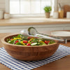 Stainless Steel Small Food Clip holding salad in a wooden bowl on a checkered tablecloth.