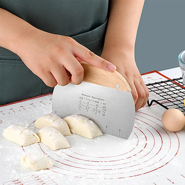 Stainless Steel Flour Sifter Baking Tool used for measuring and cutting dough on a baking mat.