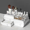 Double-Layer Cosmetics Storage Box with organized beauty products and accessories on a desk.