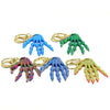 Colorful 3D Printed Skull Hand Keychain Pendant in various hues, showcasing unique design and creative detailing.