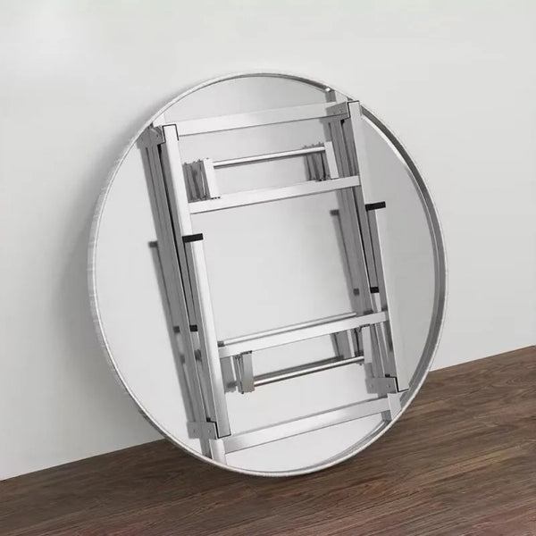 Foldable Stainless Steel Table shown in a round mirror with wooden floor background.