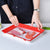 Reusable Stackable Food Preservation Trays with Stretch Covers being used to store meat and vegetables on a kitchen table.