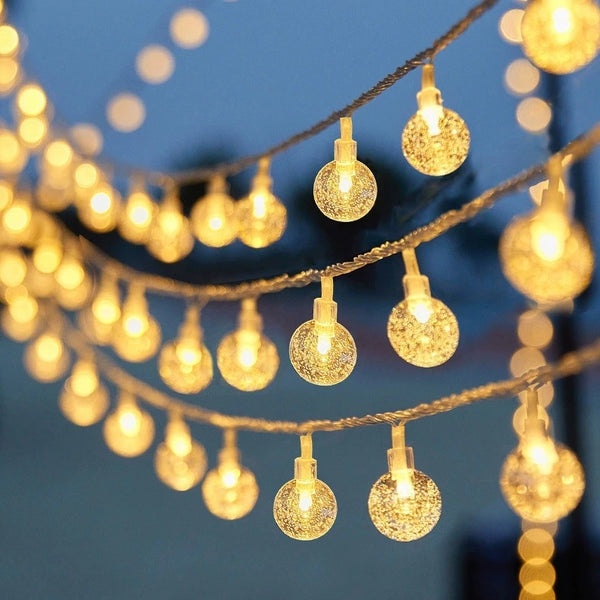 Bubble Ball Fairy String Lights illuminating a setting with glowing mini globes, perfect for festive decoration.
