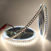 5m 12V 2835 SMD LED Strip Light rolled on a spool, showcasing its flexible design and bright illumination.