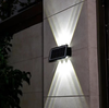 Solar LED RGB Wall Light illuminating a wall with vibrant beams, perfect for outdoor spaces.