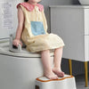 Child using Baby and Child Toilet Seat Ring on a toilet for potty training, wearing a cute dress.