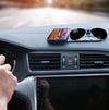 Anti-Slip Mobile Phone Stand and Holder holding a phone on a car dashboard with sunglasses.