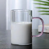 Heat Resistant Glass Beverage Cup filled with milk, showcasing its clear design and stylish pink handle.