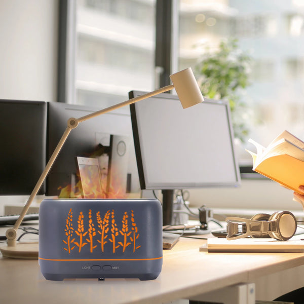 Portable 200ml 3D Warm LED Flame Humidifier Diffuser on a desk, creating a calming flame-like effect.