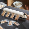 Portable Mini Food Vacuum Packing Organising Sealer in use with vacuum-sealed snack bars on a kitchen counter.
