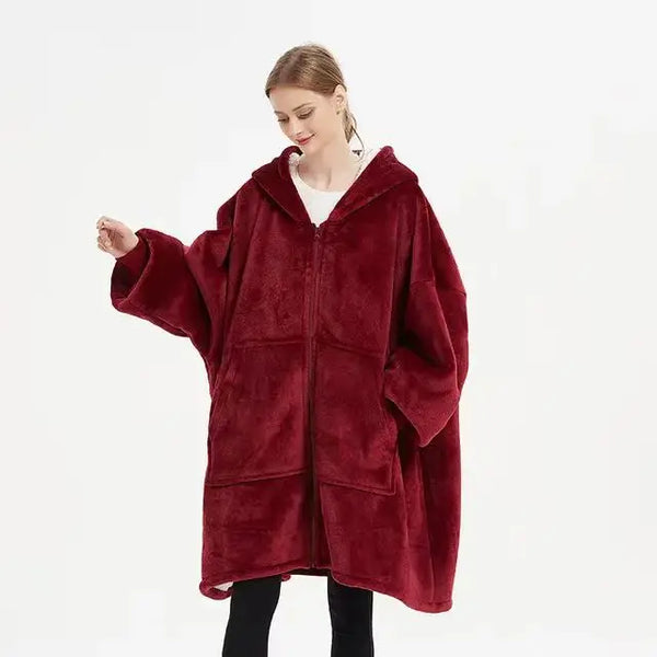 Woman wearing an Oversized Sherpa Wearable Hoodie Blanket in red, showcasing its cozy and plush design.